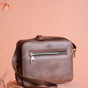 Chic brown leather bag showcased on a pastel background, highlighting stylish design.